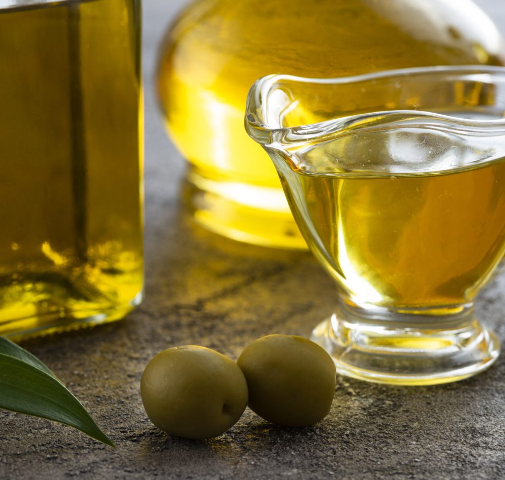 close-up-cup-olive-oil-green-olives